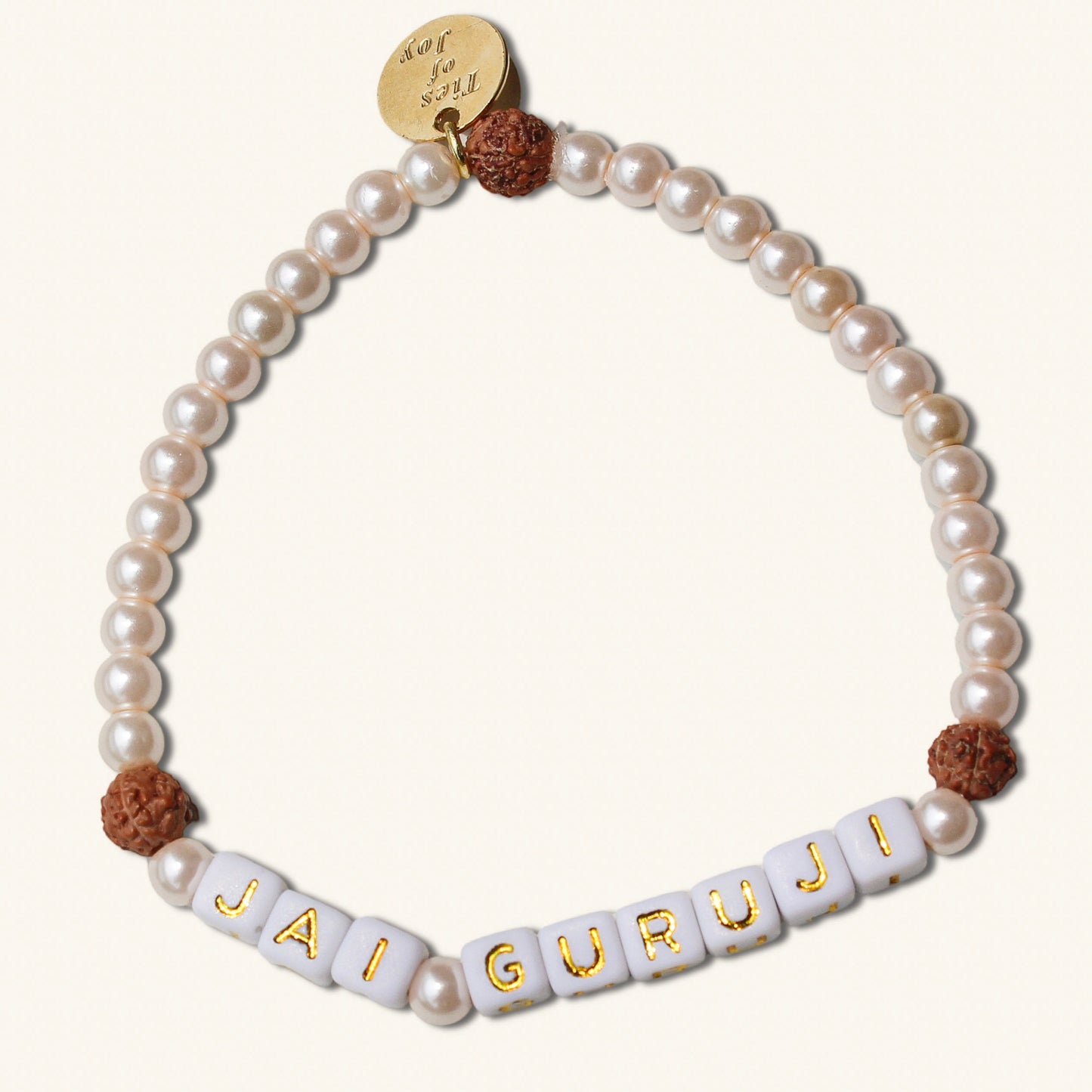 Pearl bracelet with 'JAI GURUJI' beads on a white background