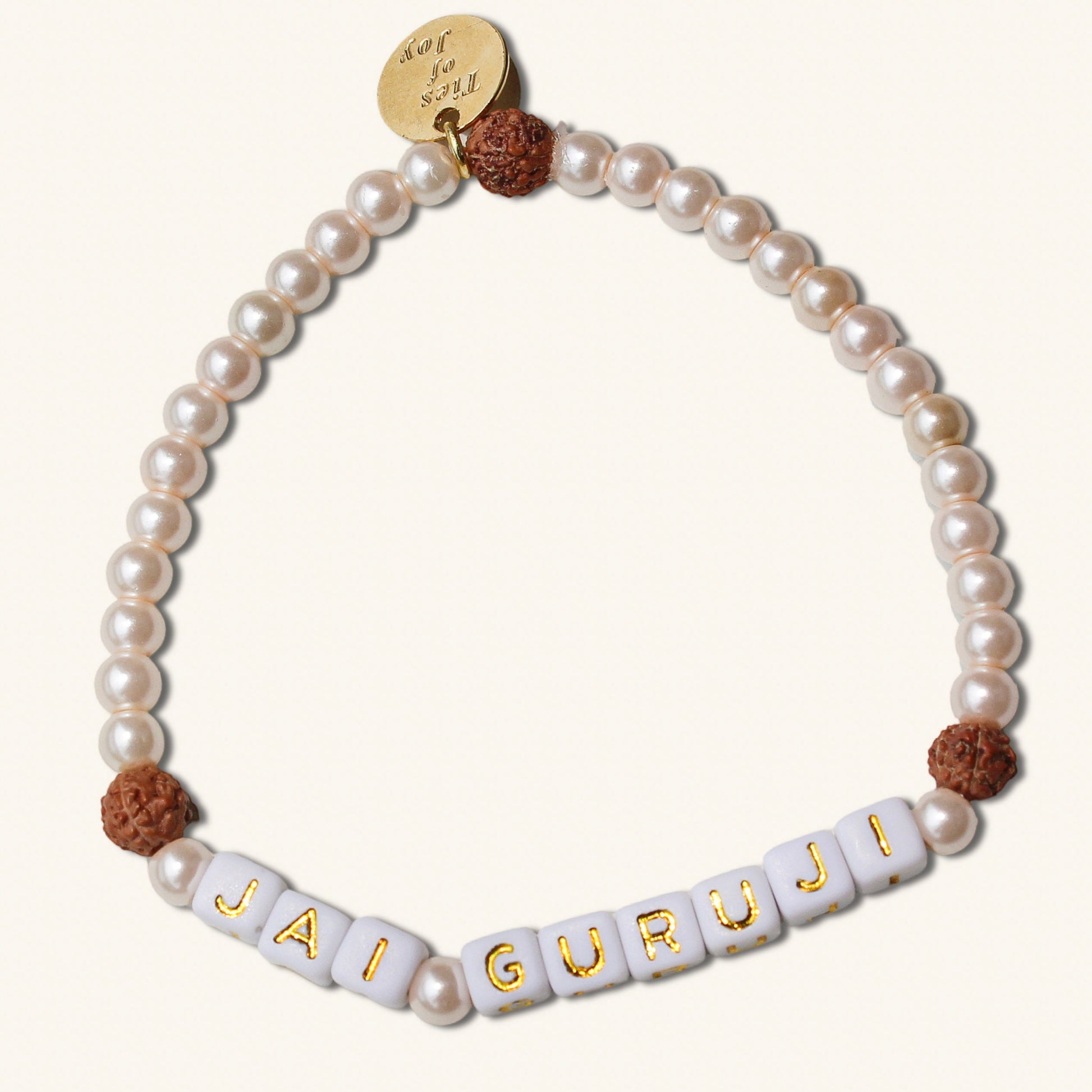 Pearl bracelet with 'JAI GURUJI' beads on a white background