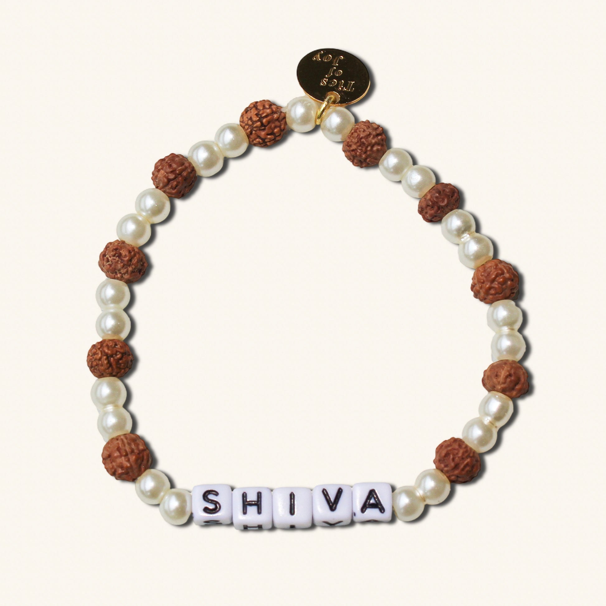 Bracelet with pearls and brown beads spelling 'SHIVA' on a white background