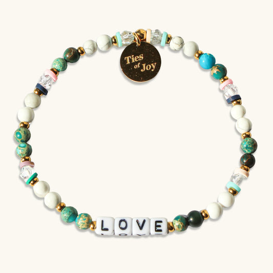 Beaded friendship bracelet with LOVE letter beads and Ties of Joy gold charm.