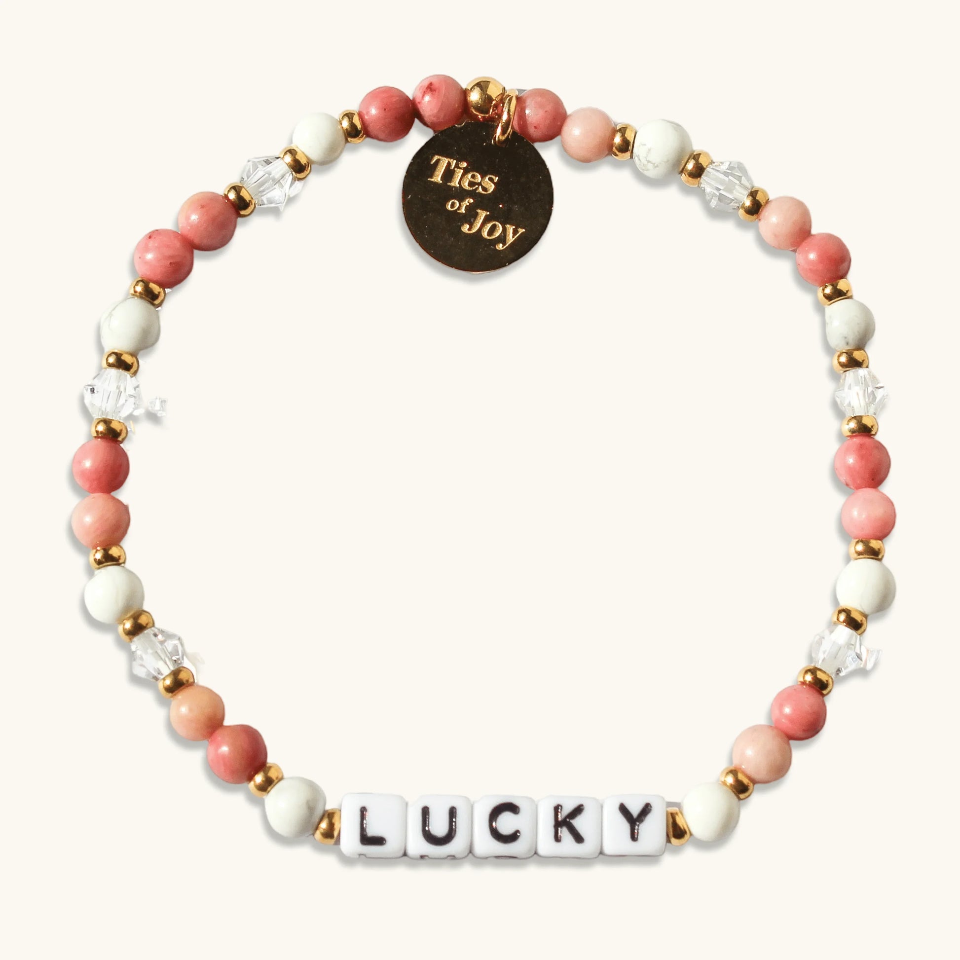 Beaded bracelet with pink, white, and gold beads, 'LUCKY' letter beads, and Ties of Joy charm