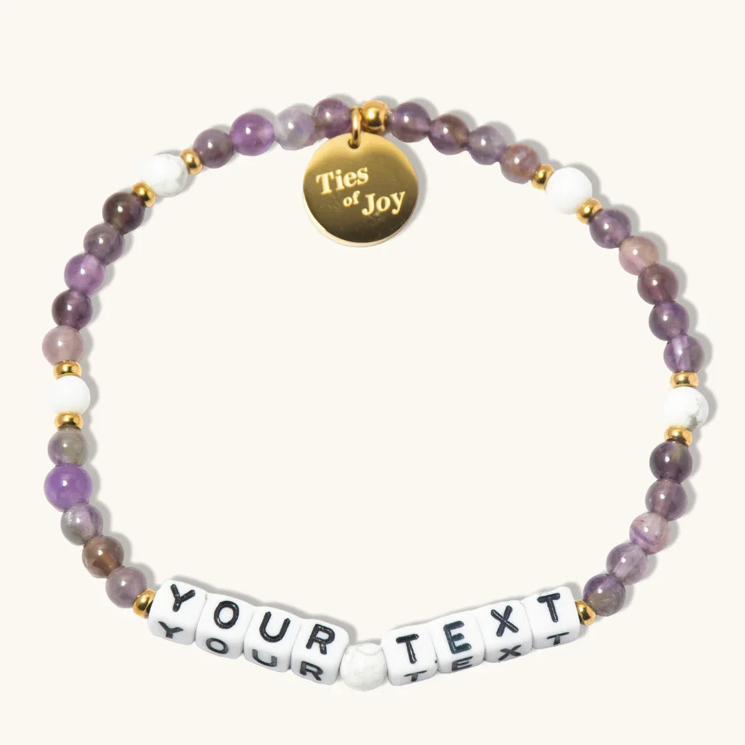Custom beaded bracelet with purple stones, gold charm reading 'Ties of Joy', and YOUR TEXT beads