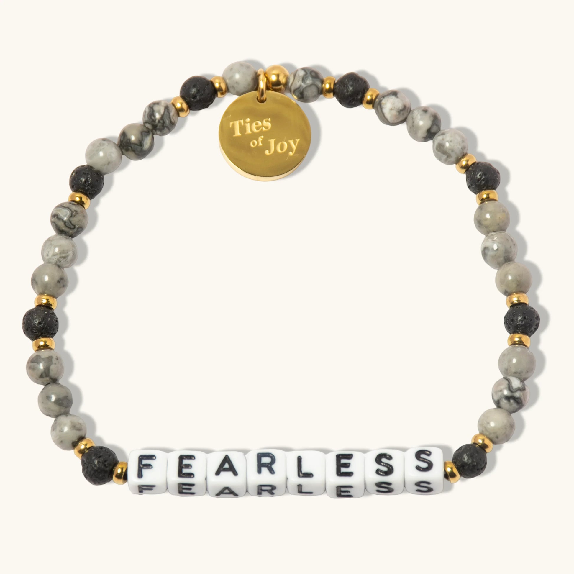 Beaded bracelet with 'FEARLESS' letter beads, gold accents, and Ties of Joy charm