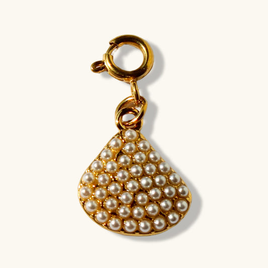 Gold shell pendant charm with pearl beads on a white background