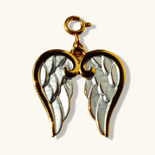 Gold and silver angel wing pendant charm against a light background