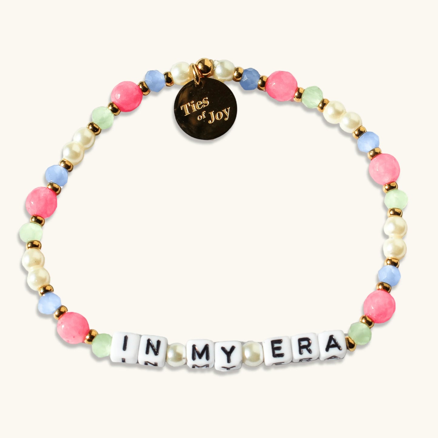 Colorful beaded bracelet with pearls, 'IN MY ERA' letter beads, and Ties of Joy charm.