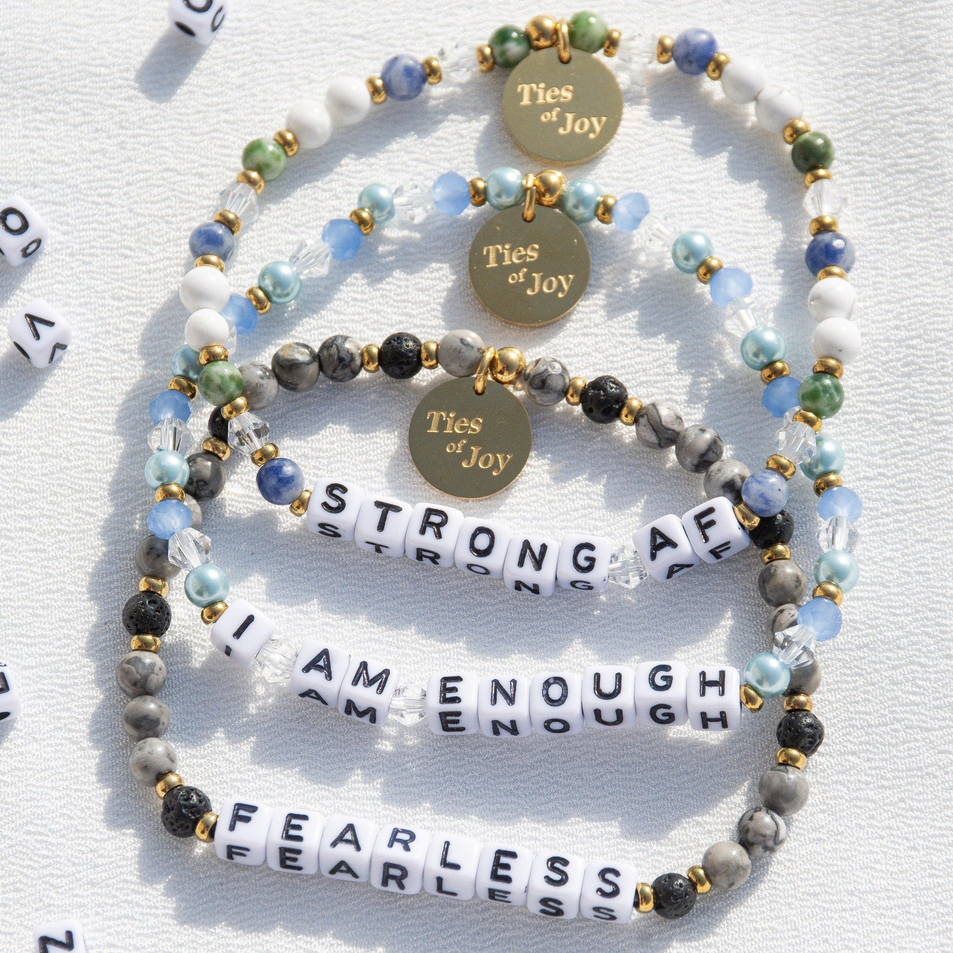 Beaded affirmation bracelets with Ties of Joy charms, phrases strong AF, I am enough, fearless